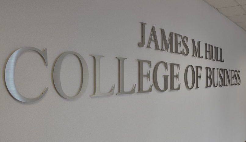 sign in a hallway that reads James M. Hull College of Business