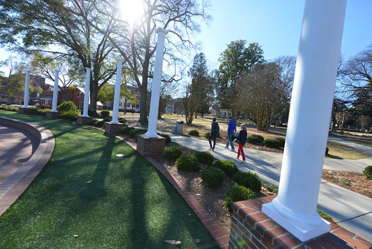 green space with students walking by