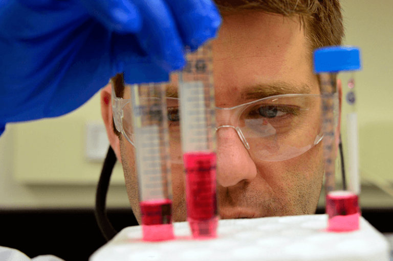 man with test tubes