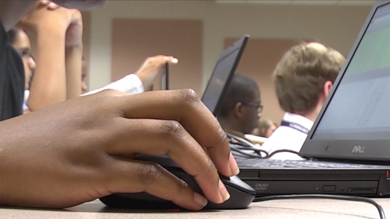 Hand on computer mouse