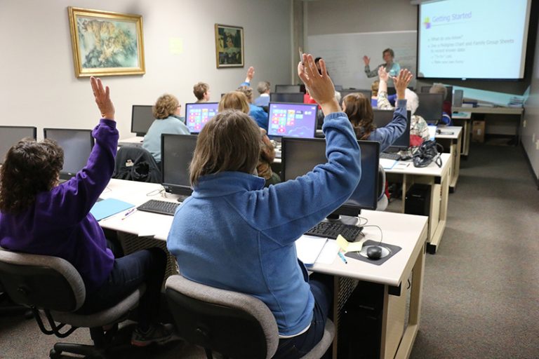 student raises hand in classroom