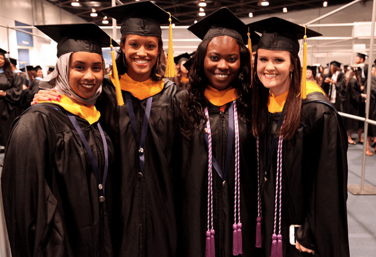 4 ladies in cap and gowns
