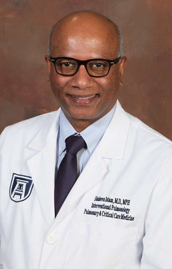 A headshot of a doctor in a lab coat.
