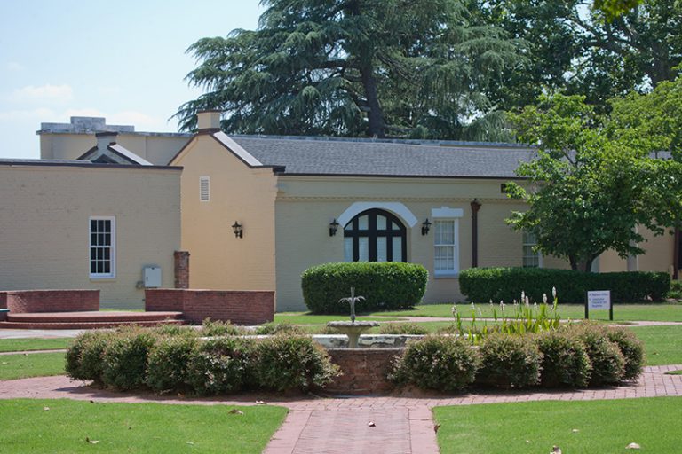 A photo of a building and a garden.