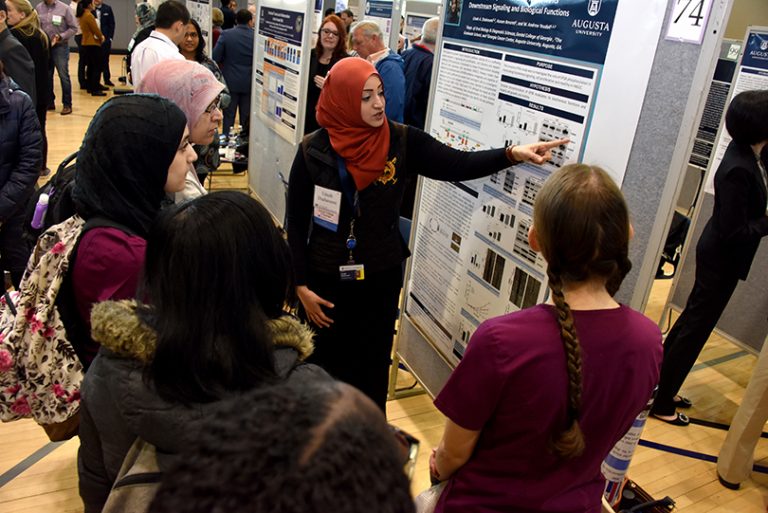 people looking at poster board