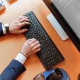 hands typing on a keyboard