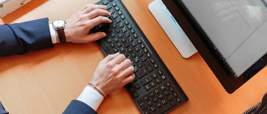 hands typing on a keyboard