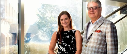 Dr. Alicia Vinyard and Dr. Edmond Ritter standing on a staircase.