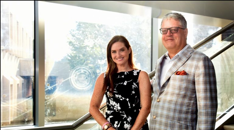 Dr. Alicia Vinyard and Dr. Edmond Ritter standing on a staircase.
