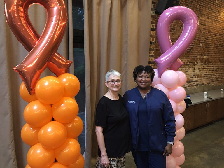 A cancer patient and nurse navigator posing for a picture.