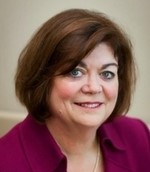 woman in a red suit posing for a headshot