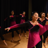 woman singing on stage