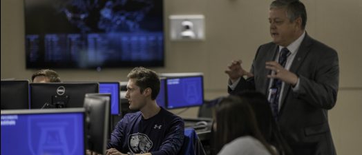 man teaching class in computer lab