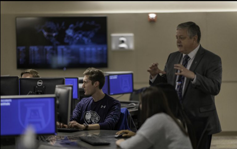 man teaching class in computer lab