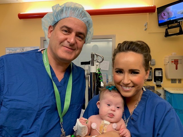 two doctors holding baby