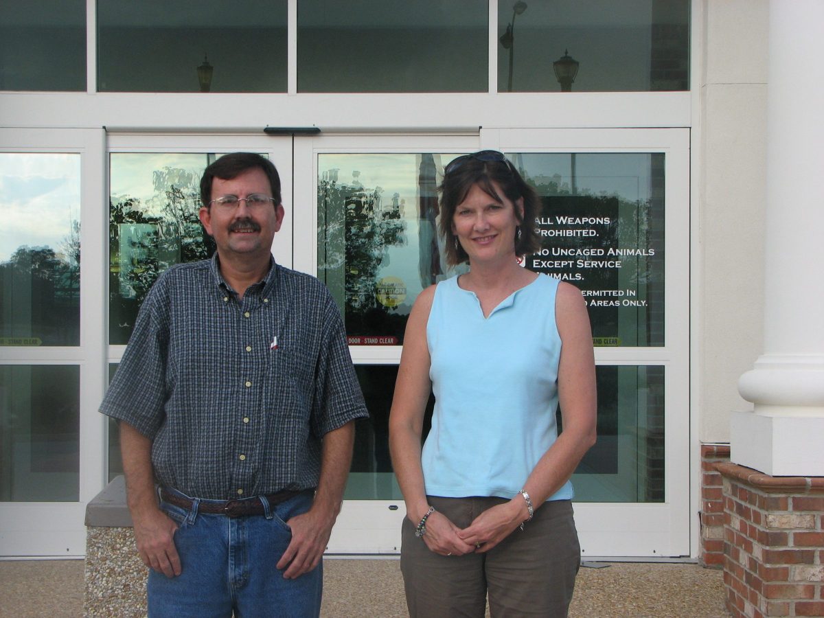 man and woman standing outside building