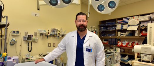 doctor standing next to lab equipment