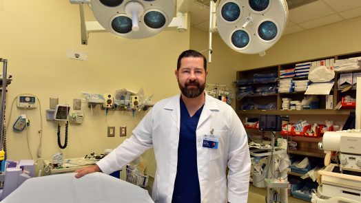 doctor standing next to lab equipment