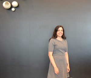 Woman standing by wall.