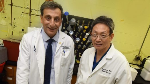 two doctors standing in front of lab equipment