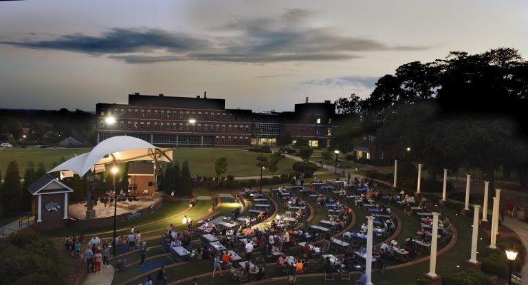A large crowd sitting at tables.