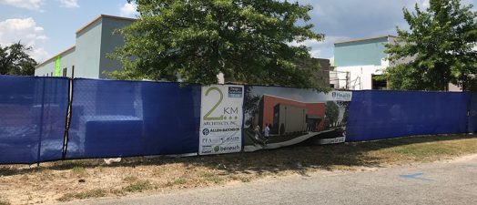 construction site next to trees and buildings