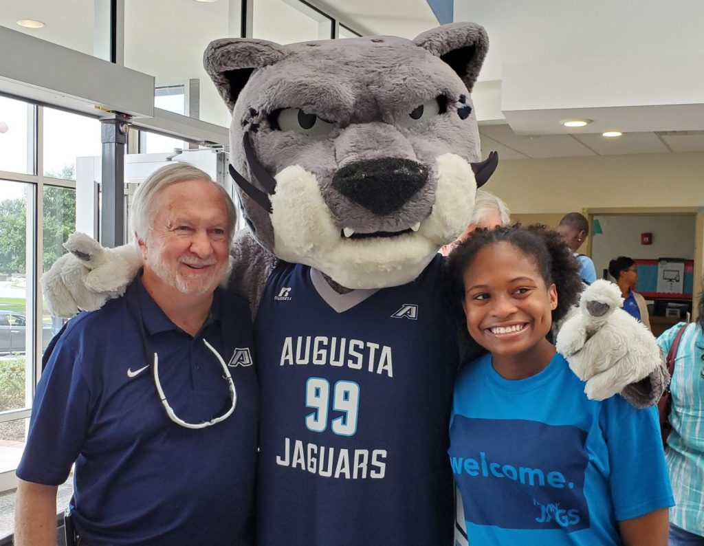 Two people and a mascot.