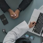 Doctor discussing image on computer screen with patient