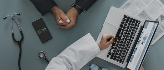 Doctor discussing image on computer screen with patient