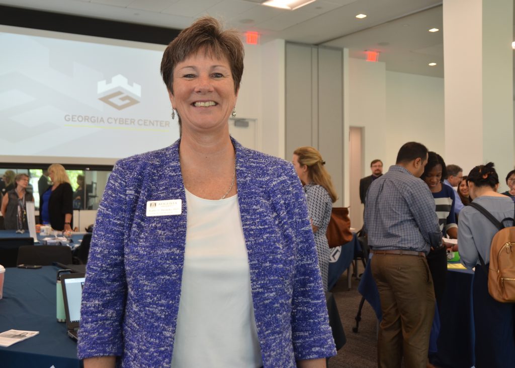 A woman standing in a conference room.