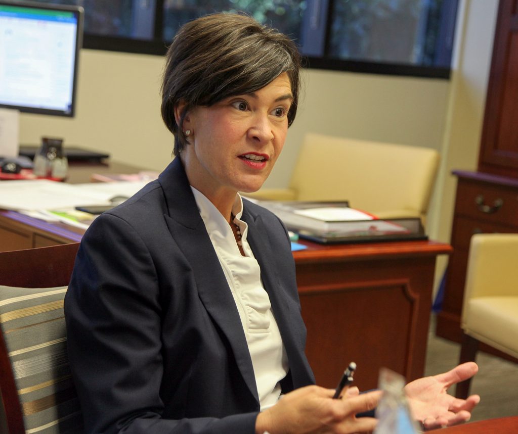 Woman talking at her desk.