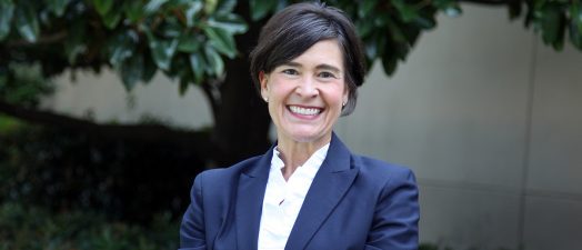 woman CEO standing outside her office building.