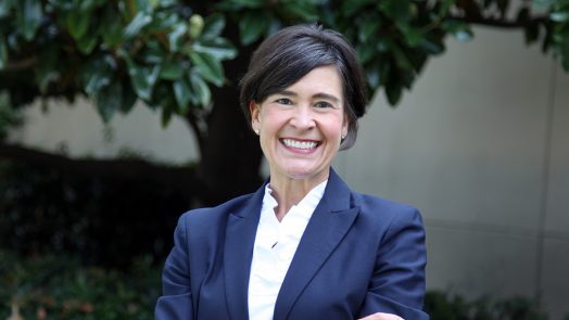 woman CEO standing outside her office building.