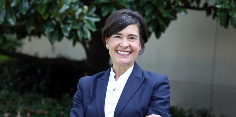 woman CEO standing outside her office building.