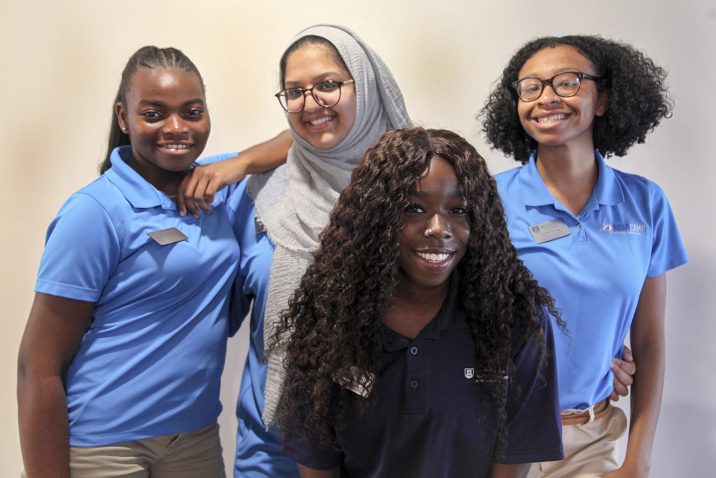 four students smiling