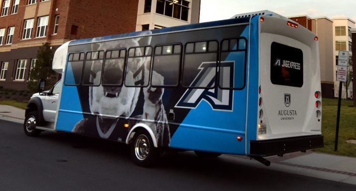 Color photo of Augusta University shuttle with mascot Augustus and the athletic A