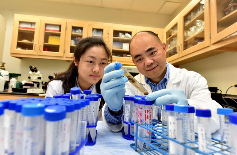 two doctors looking at lab equipment