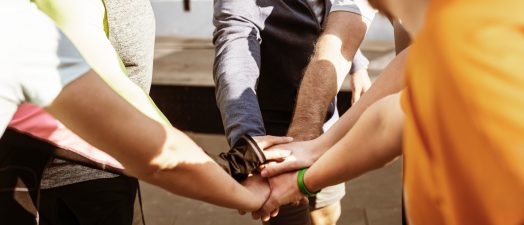 people putting their hands in a circle