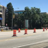 Orange and white construction drums lined up along 15th Street in front of AU Medical Center