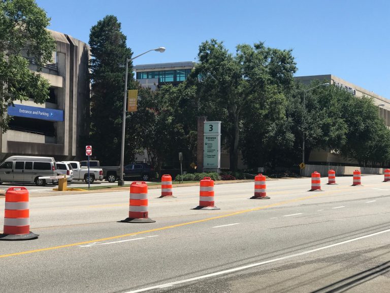 Orange and white construction drums lined up along 15th Street in front of AU Medical Center