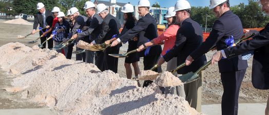 People shoveling sand