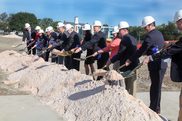 People shoveling sand