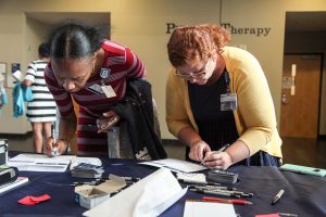 two women filling out paperwork