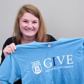 women holding up t-shirt