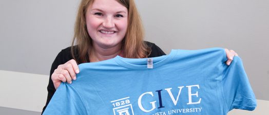women holding up t-shirt