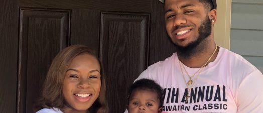 mom and day holding baby