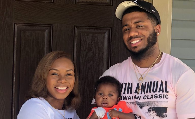 mom and day holding baby