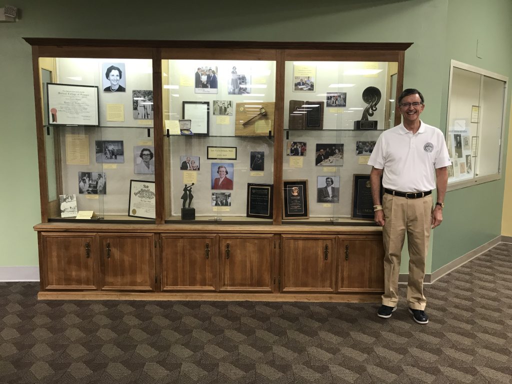 Man standing by an exhibit.