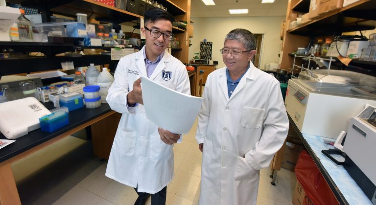two doctors talking in the lab with paperwork