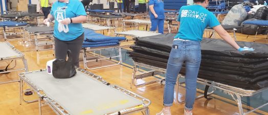 Volunteers put up cots